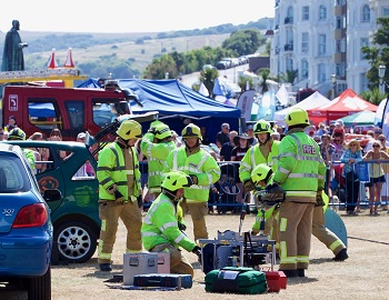 999 Event Firefighters next to car